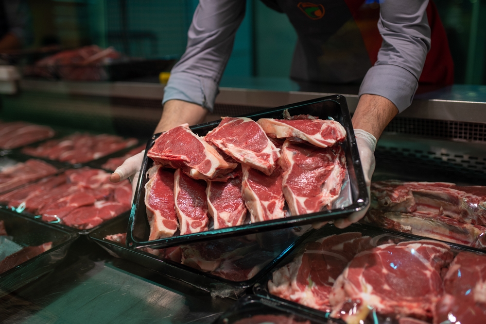 Closeup,Of,Butcher's,Hands,Holding,Meat,Piece,In,Shop